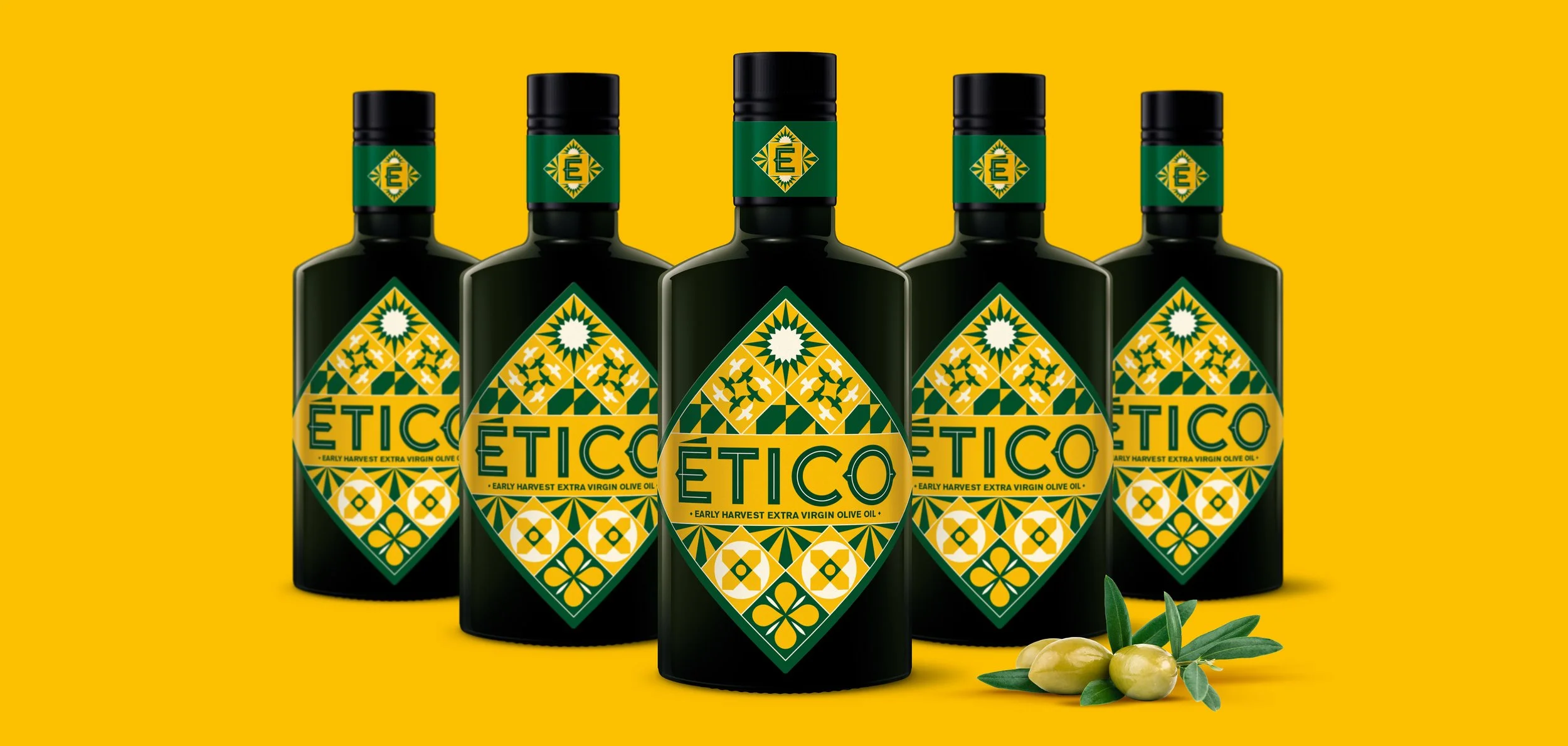 Five bottles of Ético Extra Virgin Olive Oil on a yellow background.