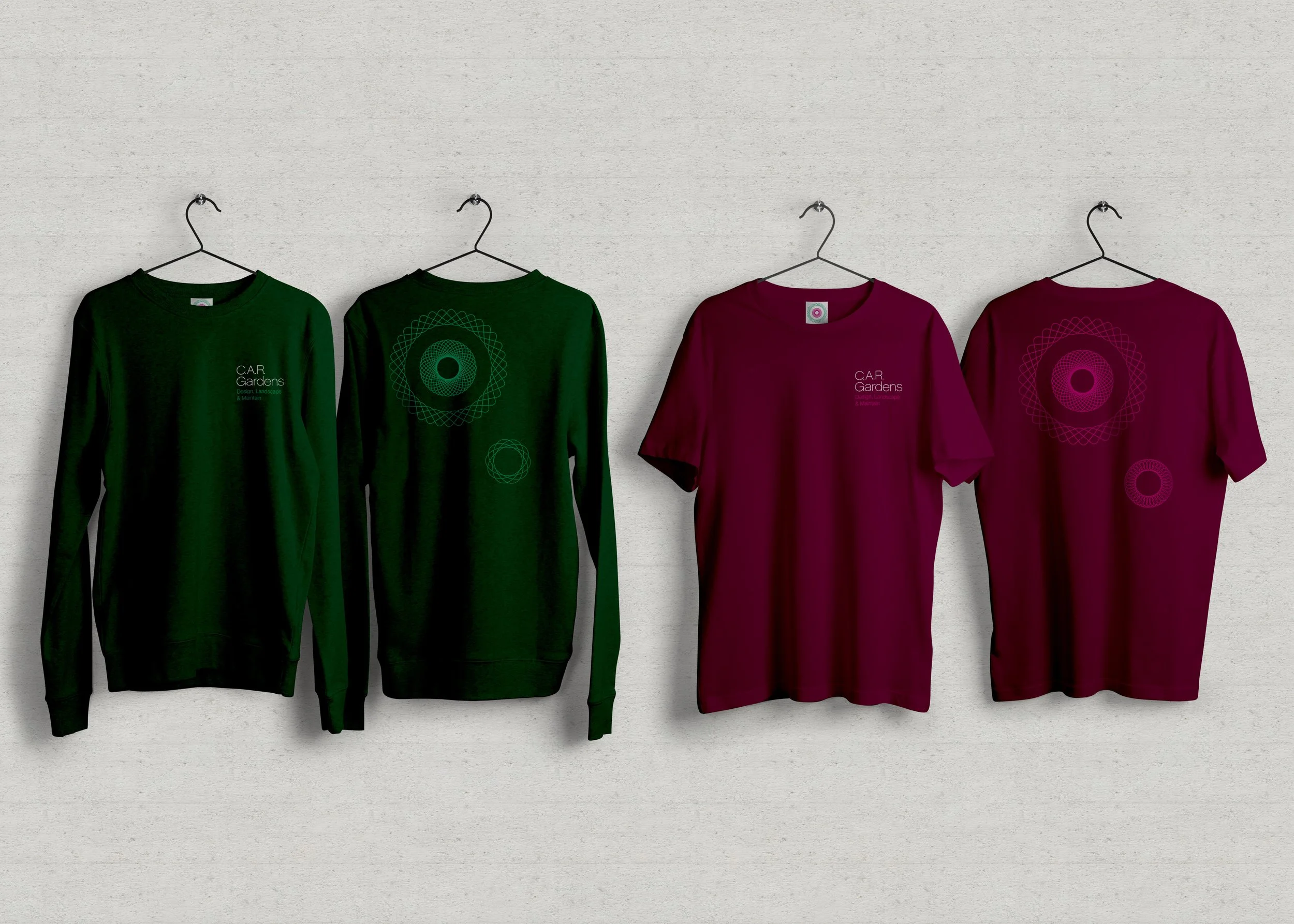 C.A.R. Gardens staff uniform - sweater and t-shirt - in dark green and maroon - both with C.A.R. Gardens branding and freeform spirographs.