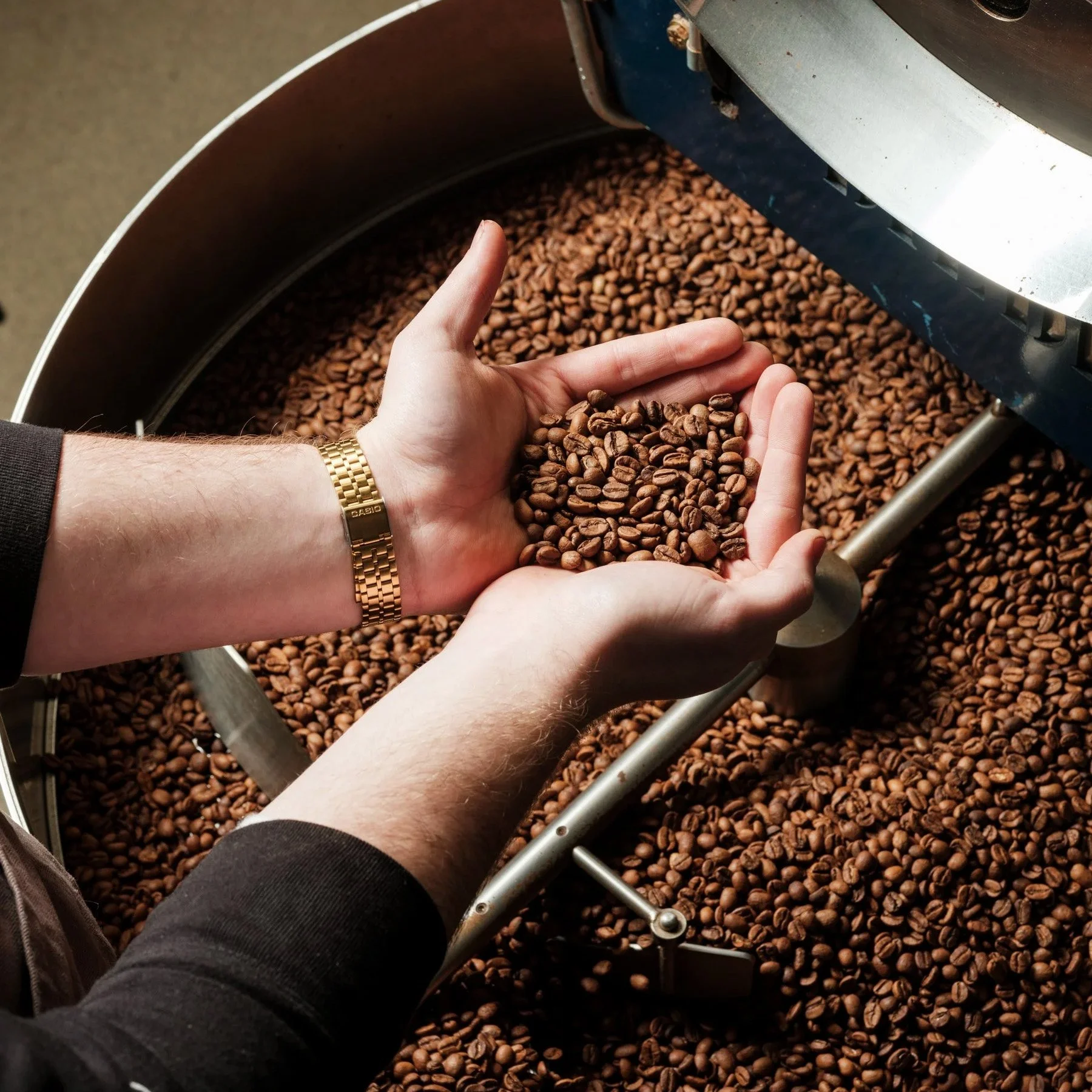 A Bean Shot roaster samples freshly roasted coffee beans at the brand’s roastery.