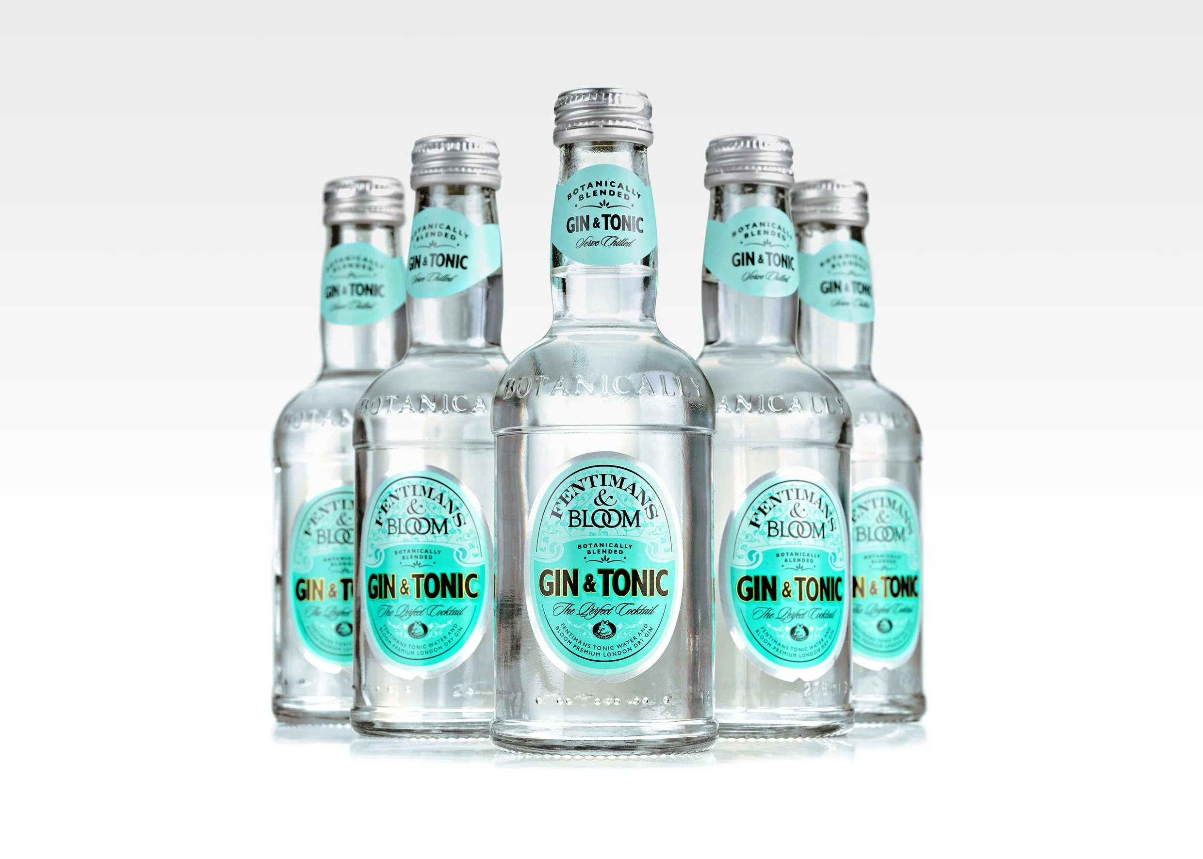 Fentimans & Bloom - Six clear glass bottles of gin and tonic with blue labels, arranged in a group on a white background.
