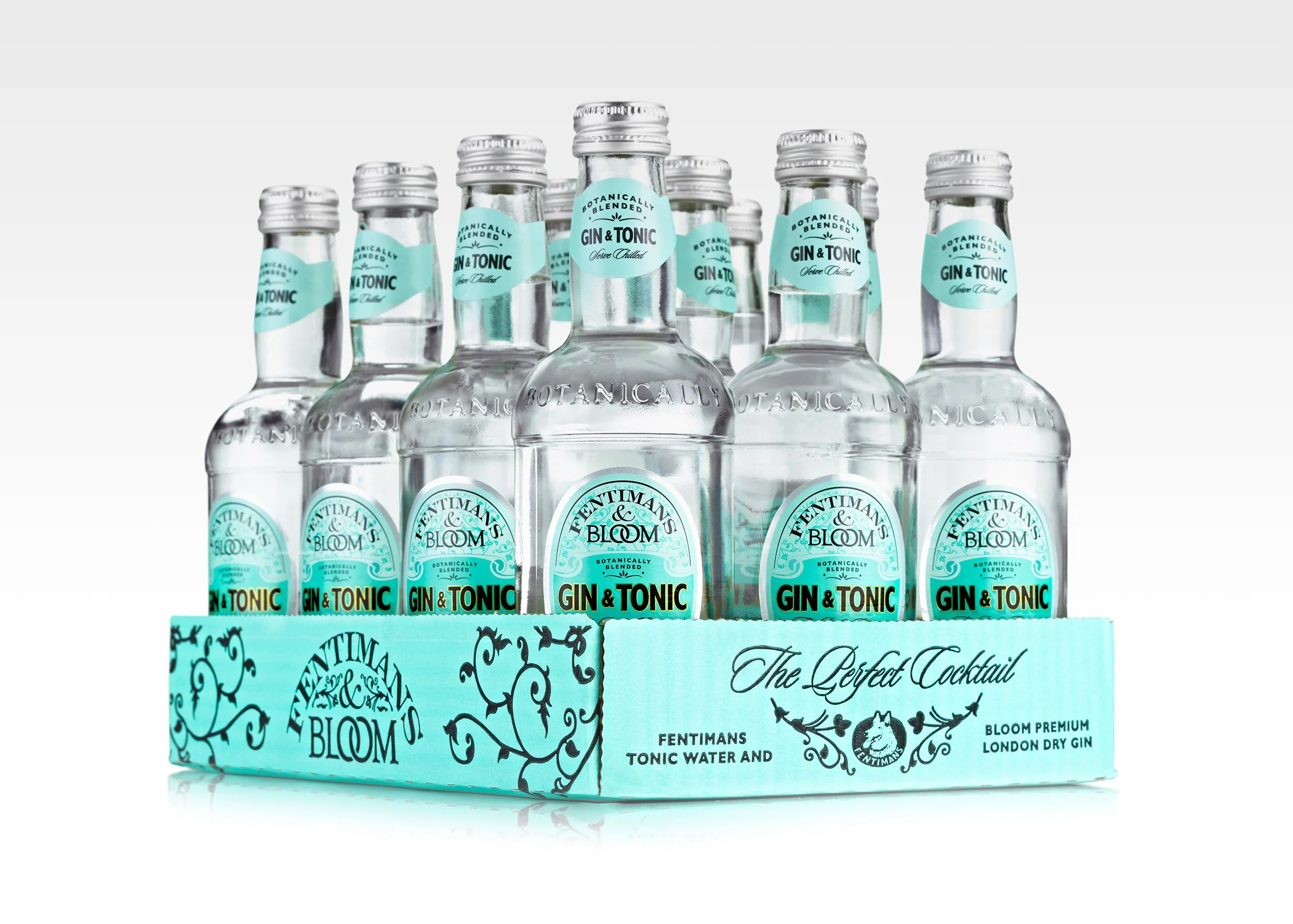 Fentimans & Bloom - A pack of eight bottles of Fentimans Botanically Blended Gin & Tonic with tonic water and London dry gin, arranged in a circular formation in a blue box labeled 'The Perfect Cocktail' with decorative black swirl patterns.