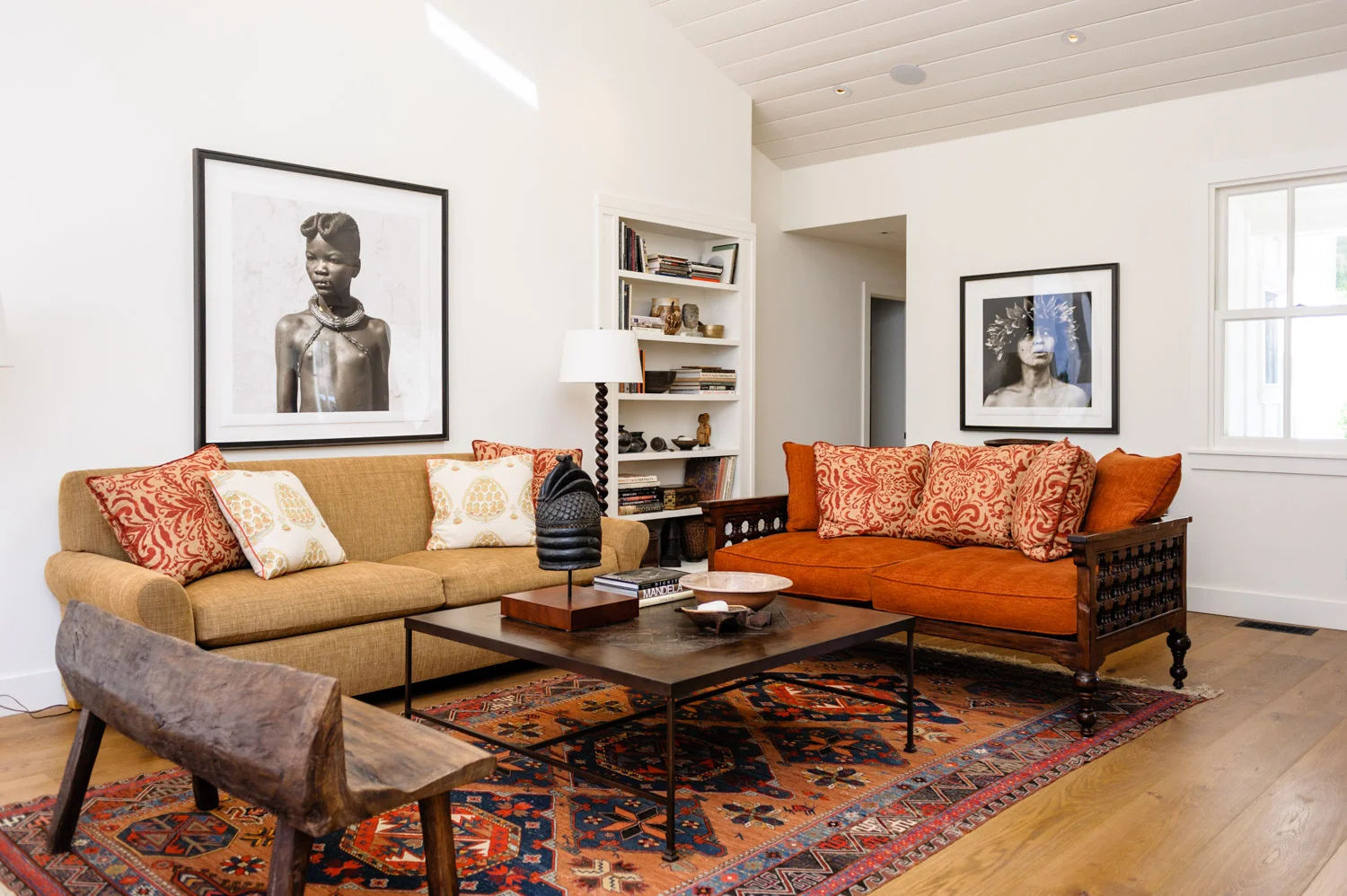 Living room featuring African textiles, bench & art.