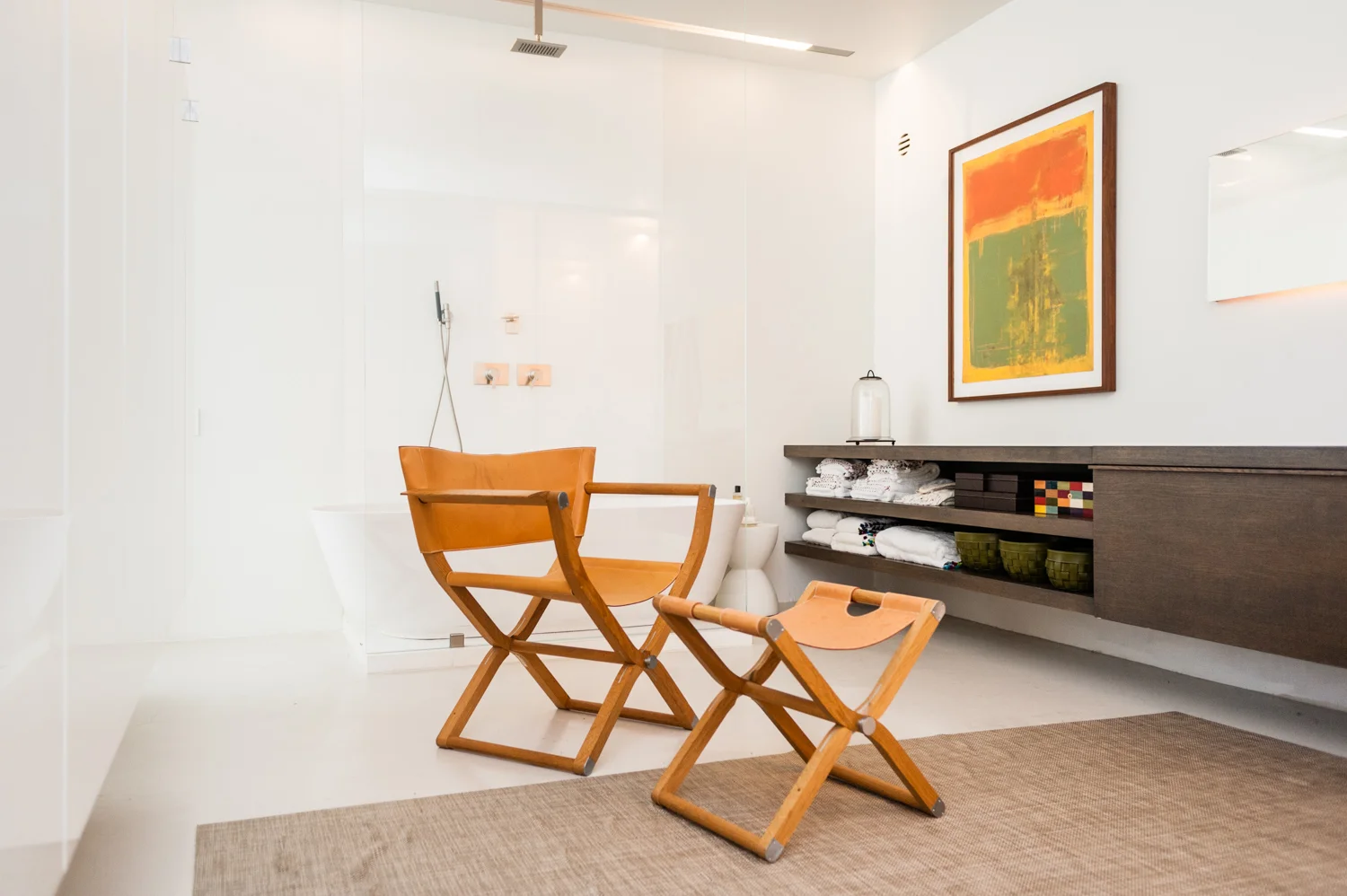 Leather chair and footrest in upscale bathroom.