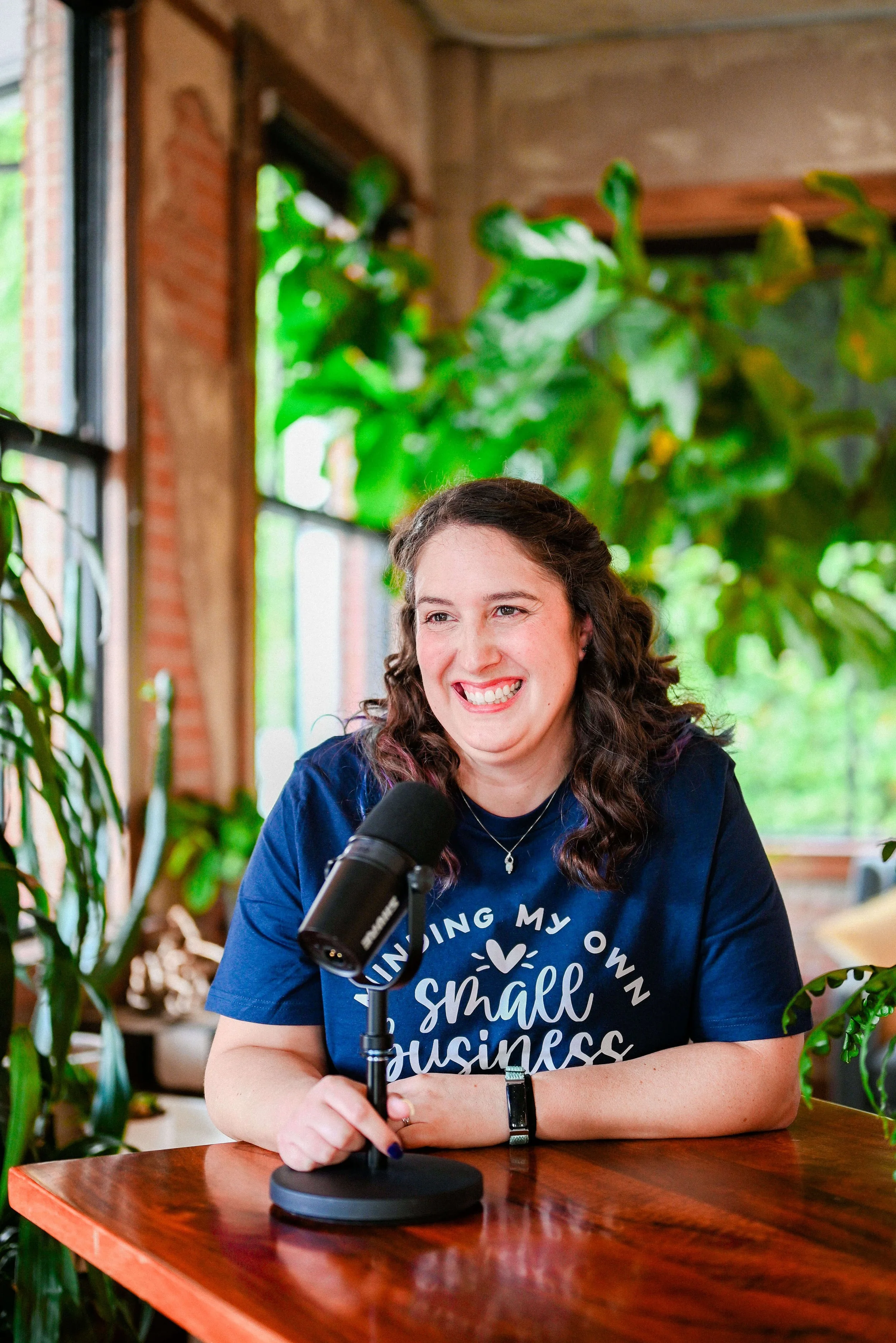 Samantha Mabe, website designer and host of the Elevate Your Practice podcast, talking into microphone.