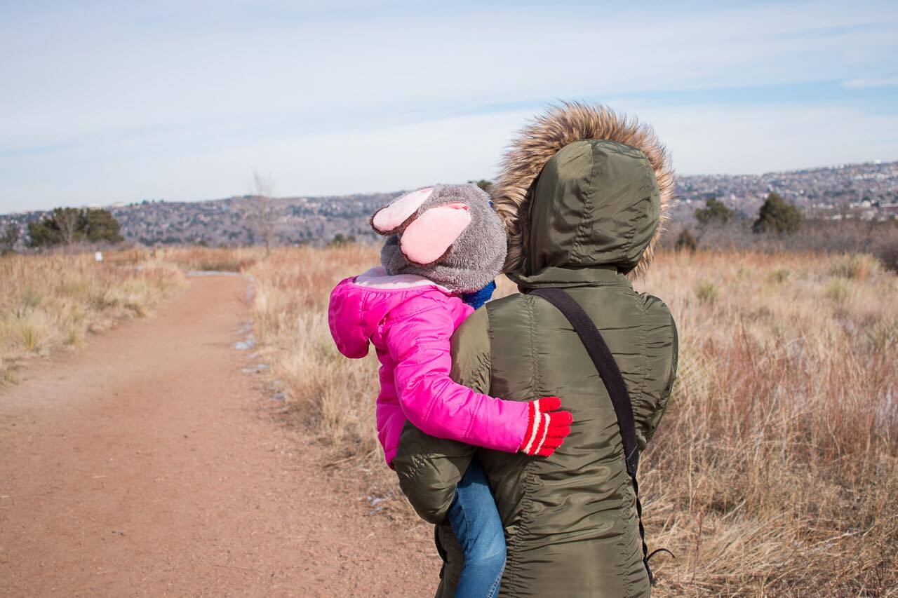 Two Kids In Tow My daughter is usually my hiking buddy and she loves when we go hiking with our friends and she was doing really well at the beginning, but the more we hiked it seemed like the colder she got. The sun was coming in and out at this point, more in than out. As she got colder, the more she begged for me to pick her up. Now carrying a 34lb, 4 year old can be challenging especially when you are not prepared to carry them. I didn't have my Onya soft carrier that she surprisingly still fits in so a regular hip carry was all I could do. We took breaks so that she could walk, which she was not happy about. Luckily as we were heading back to the cars one of the Mom's had a sucker and that turned her misery around and gave my arms a break. They were sore the next day though. 