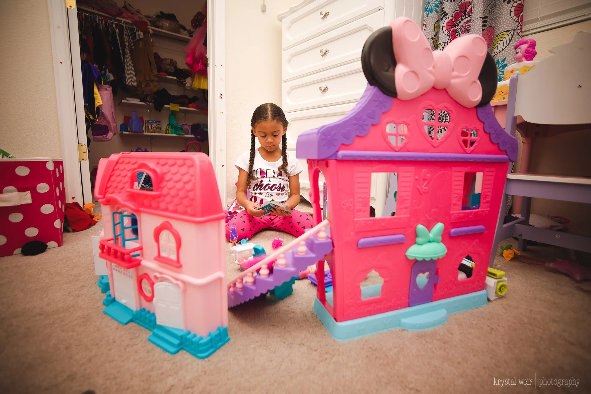 Day 11/365 I love to watch her play. She has a great imagination. Here we are playing Trolls...again. She loves to reenact the movie and she gives me lines and sets up the scene. It's a pretty big production. I focused on framing to add a little interest to this photo. I shot through windows of the dollhouse, I shot from above and this was one of the last shots and ideas I had. She was perfectly framed between these two houses and my wide angle lens made the houses look bigger than they were. I also used my speed light/external flash on top of my camera to get the lighting nice and bright. 