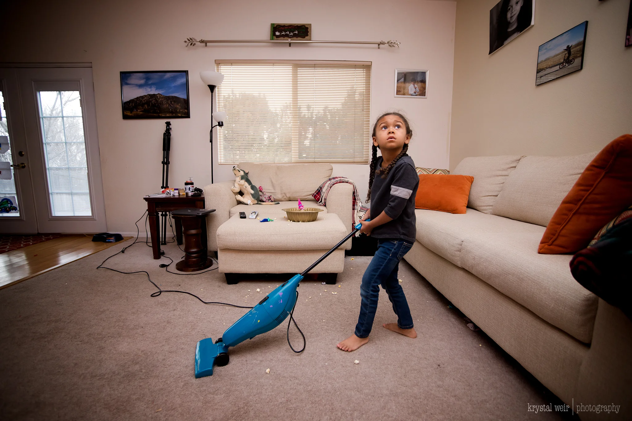 Day 12/365 When you leave a 4 year old alone with a bowl of popcorn and the next thing you know there is popcorn everywhere! Trying to teach them young how to clean up after themselves, they forget most times. She can't really handle the larger vacuum so I pull this kid friendly vacuum out for the littles to use. As you can see she wasn't really trying to clean her mess, but she eventual cleaned a bit of it up. Here I used my trusty wide angle again to include the surroundings and add context to the story.. I also used my external flash because it was quite dark in the living room and using the flash allowed me to use a lower ISO and add nice lighting to this image. Â