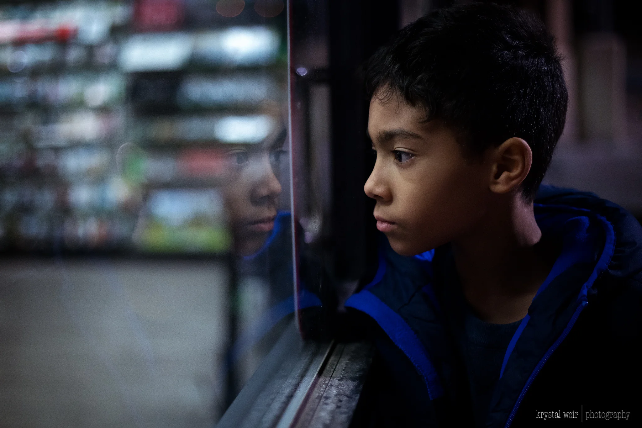 Day 13/365 Creating a moment in unexpected places Today was a busy day out and I had my camera with me of course, but not until the end of the night did I get the shot I wanted. Outside waiting for my husband, my son was looking in, in the most focused way. I saw a glimpse of his reflection and hoped that he stayed there until I dialed in my settings. It was late and the only light source I had were the store lights. I made sure to expose for his face because that was the important part of the image. My ISO was pretty high, 3200 which leads to grain or noise in which I wasn't a huge fan of until recently. I think grain in the right situation can give a photo character as long as it's not too blotchy. In this photo it does work. I just love a good reflection shot so you may see more of them this year. As for editing I knew I wanted a cooler temperature edit because it was night and it reflected the environment accurately. When editing like this I usually play around with the white balance and the blues in Lightroom. What I do struggle with when I edit like this are the skin tones because you want the skin to look natural and not too blue so you will also have to find ways to balance it out. 