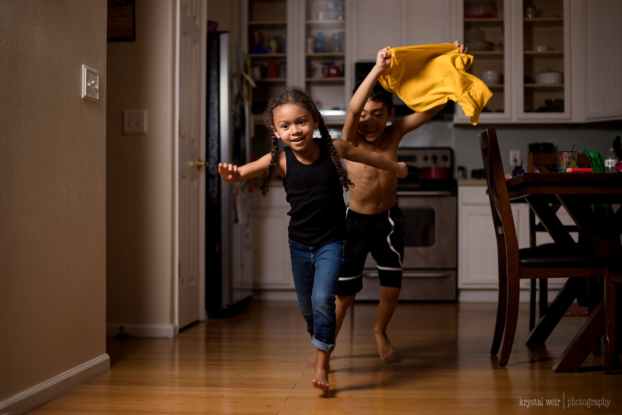 Day 28/365 ❤️Siblings at Play❤️ The last shot of the week is possibly my fave shot of the week. They made me move the kitchen table back so they had enough room to run back and forth between the kitchen and living room. My lighting setup was already in place from earlier in the day. i photographed many photos as I do get snap happy. This one was perfect because it captured their action perfectly. Their expressions were captured perfectly as well. As I said in a few photos above the lighting just added depth to this photo and highlighted the subjects perfectly. How many times can I say perfectly?! 