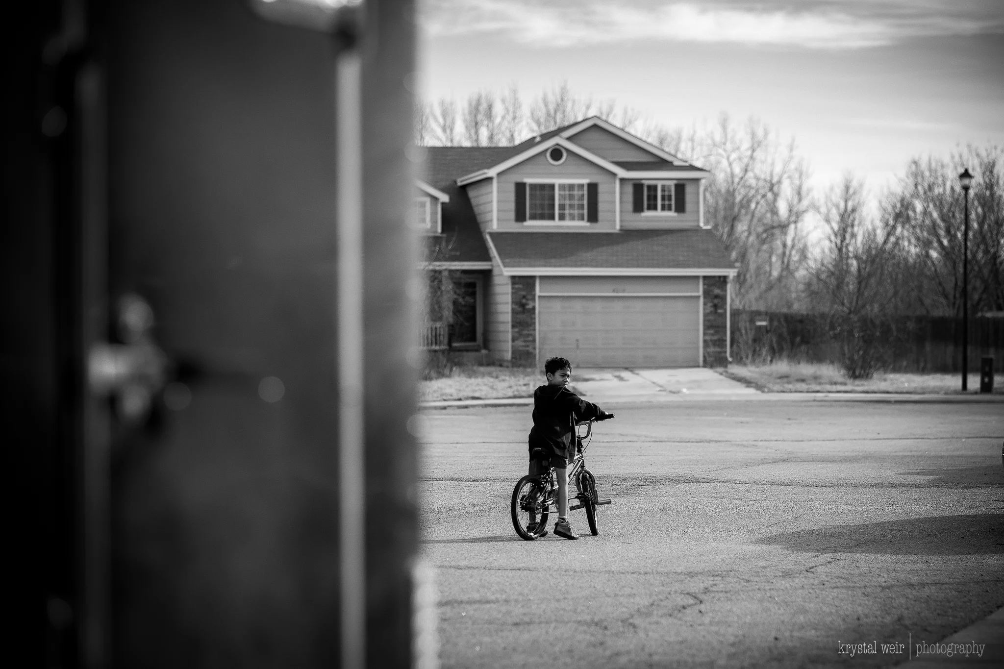 Day 29/365 When it's almost 60° outside in January, you not only make the kids #getoutdoors, but you get your butt out there too! I was catching up to the kid and there was a trailer on the side of the road and I decided to use it to frame my son. I wanted to edit this photo in color, but my edits were not turning out the way I envisioned so my go to was a b&w edit. 