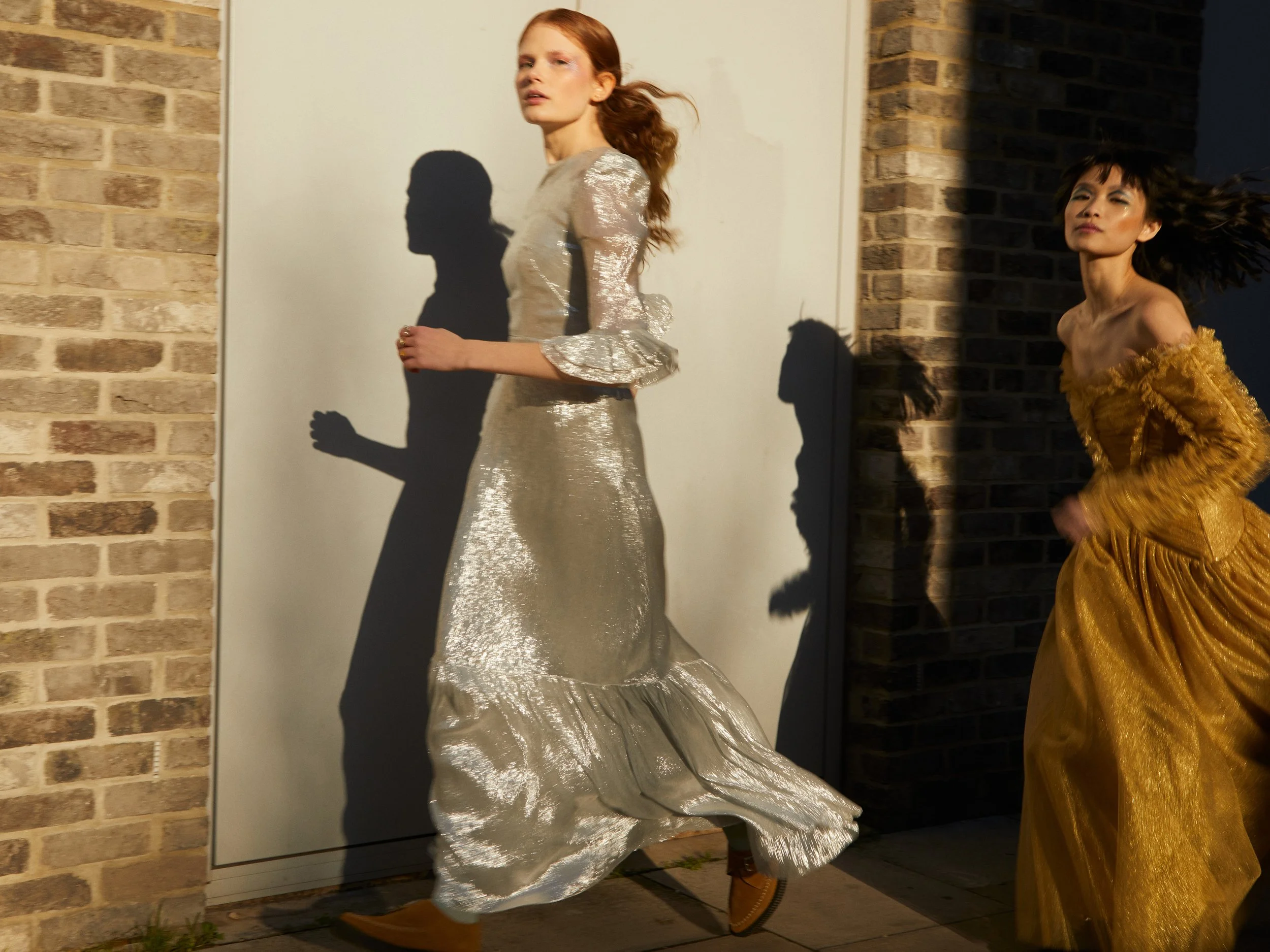 Holly wears Dress by THE VAMPIRE'S WIFE, Shoes by RE/DONE; Rulan wears Dress by ZIMMERMAN