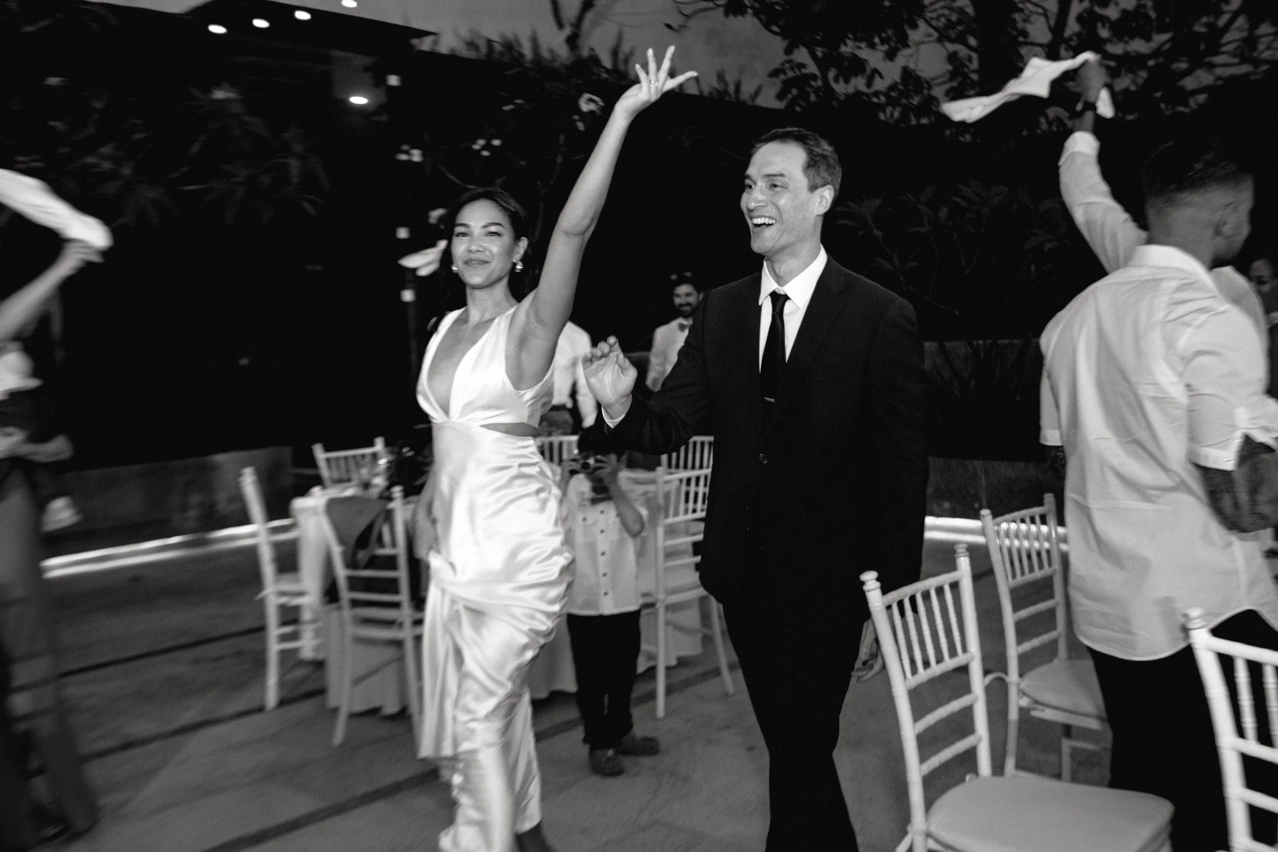 A couple celebrating with their guests during a destination wedding reception photographed by Arch Wedding Studio in the Riviera Maya