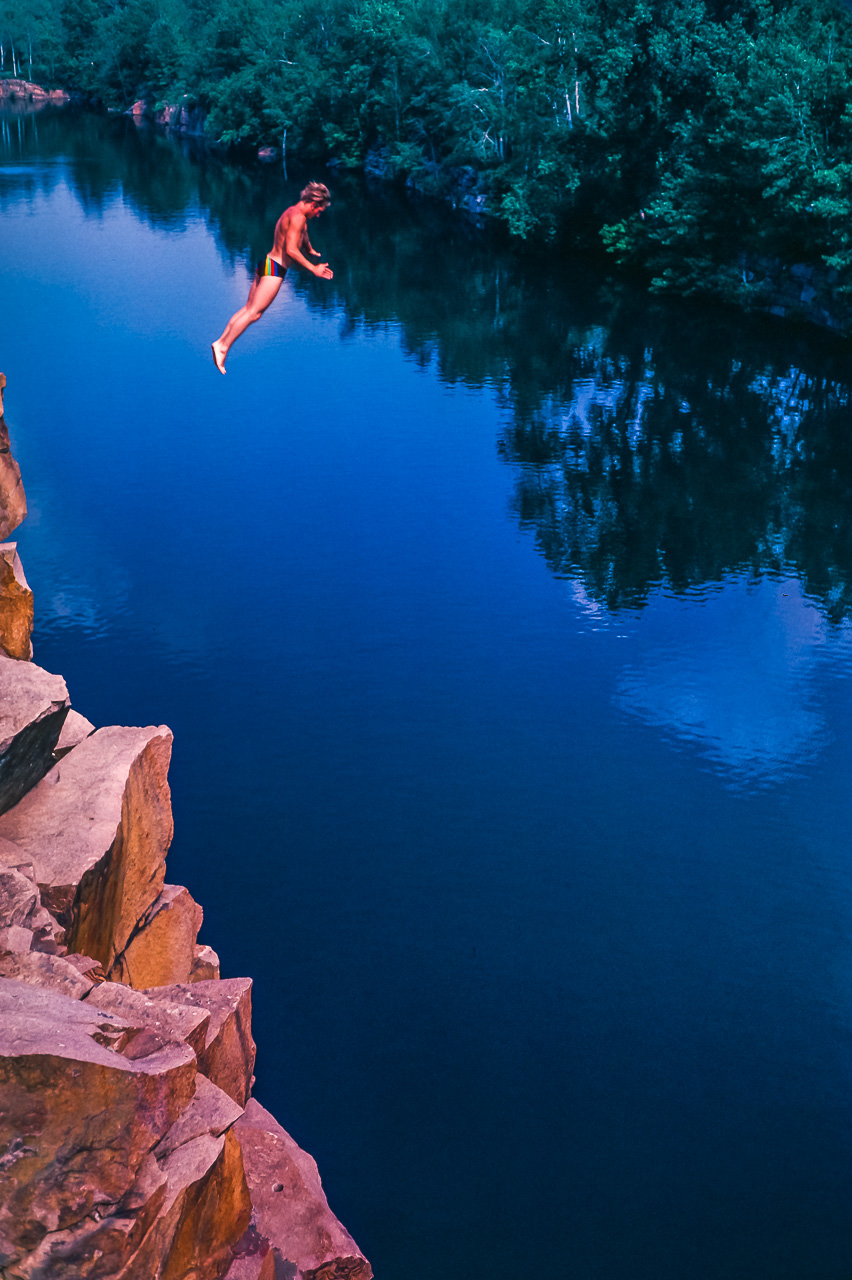 Brave Cliff Diver In Flight