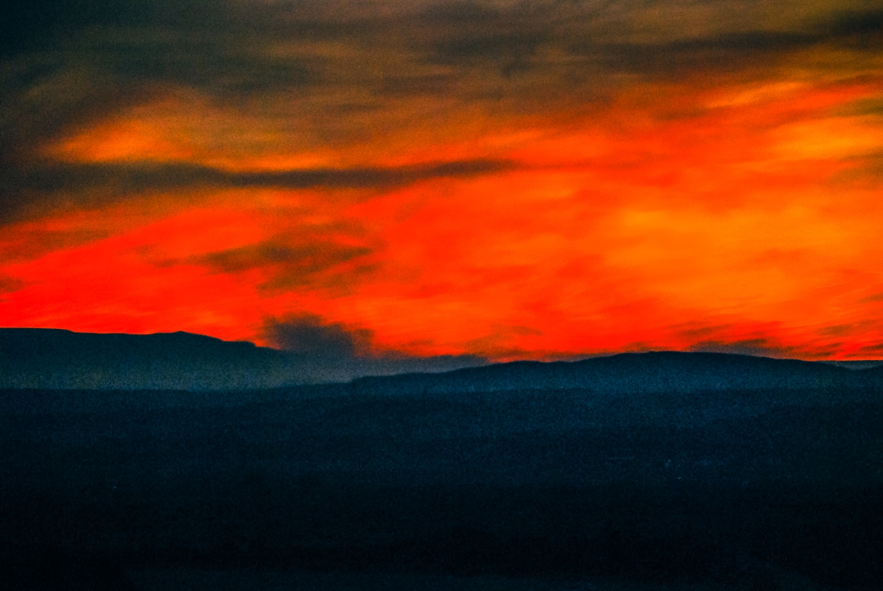 Fiery Skies as Forest Fire Shadows Sunset