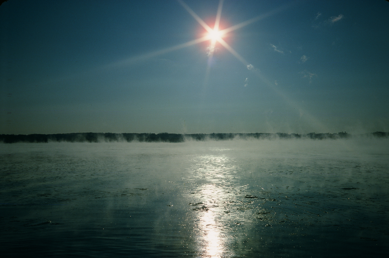 Starburst Sun Over Steam As Deep Lake Meets Freezing Air