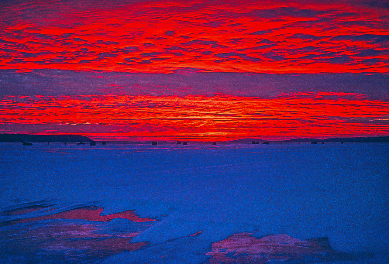 RED SUNSET BATHES GREEN LAKE ICE FISHING VILLAGE (1984)