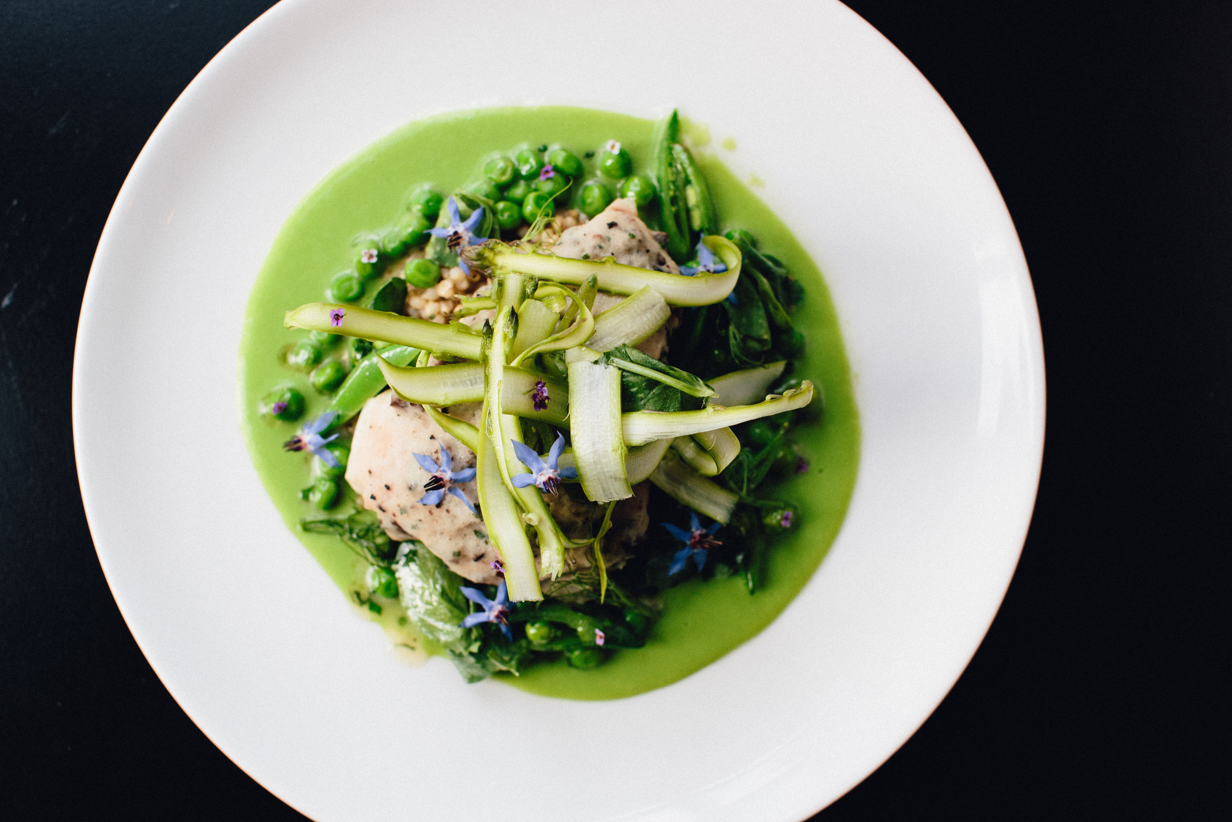 Steamed Red Snapper encrusted with a scallop & truffle mousse. Served over sorghum grains with a pea butter, spring peas, sugar snap peas, shaved raw asparagus, mint. Dressed with white balsamic vinaigrette.