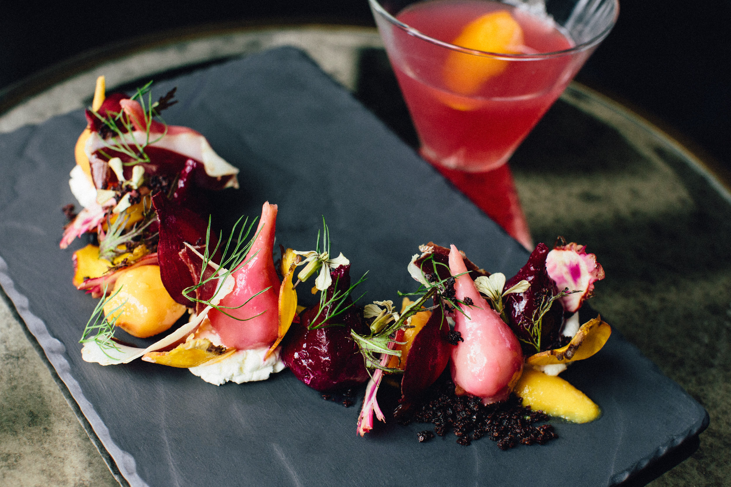 Beets Two Ways: Shaved Raw & Roasted. Candy Cane, Ruby Red & Golden Beet. Valencia Orange Purée. Smoked Goat Cheese. Duck Prosciutto. Liquorice Soil (made of star anise, dried olives and raw sugar). Garnished with fennel fronds & arugula flowers. 