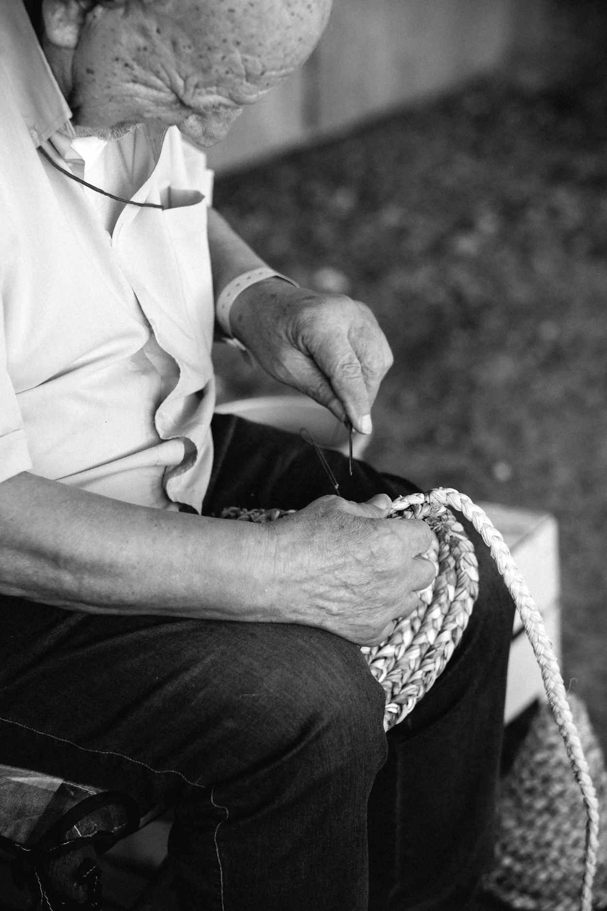 Man weaving baskets by hand, with 100% natural marsh grasses - see left.