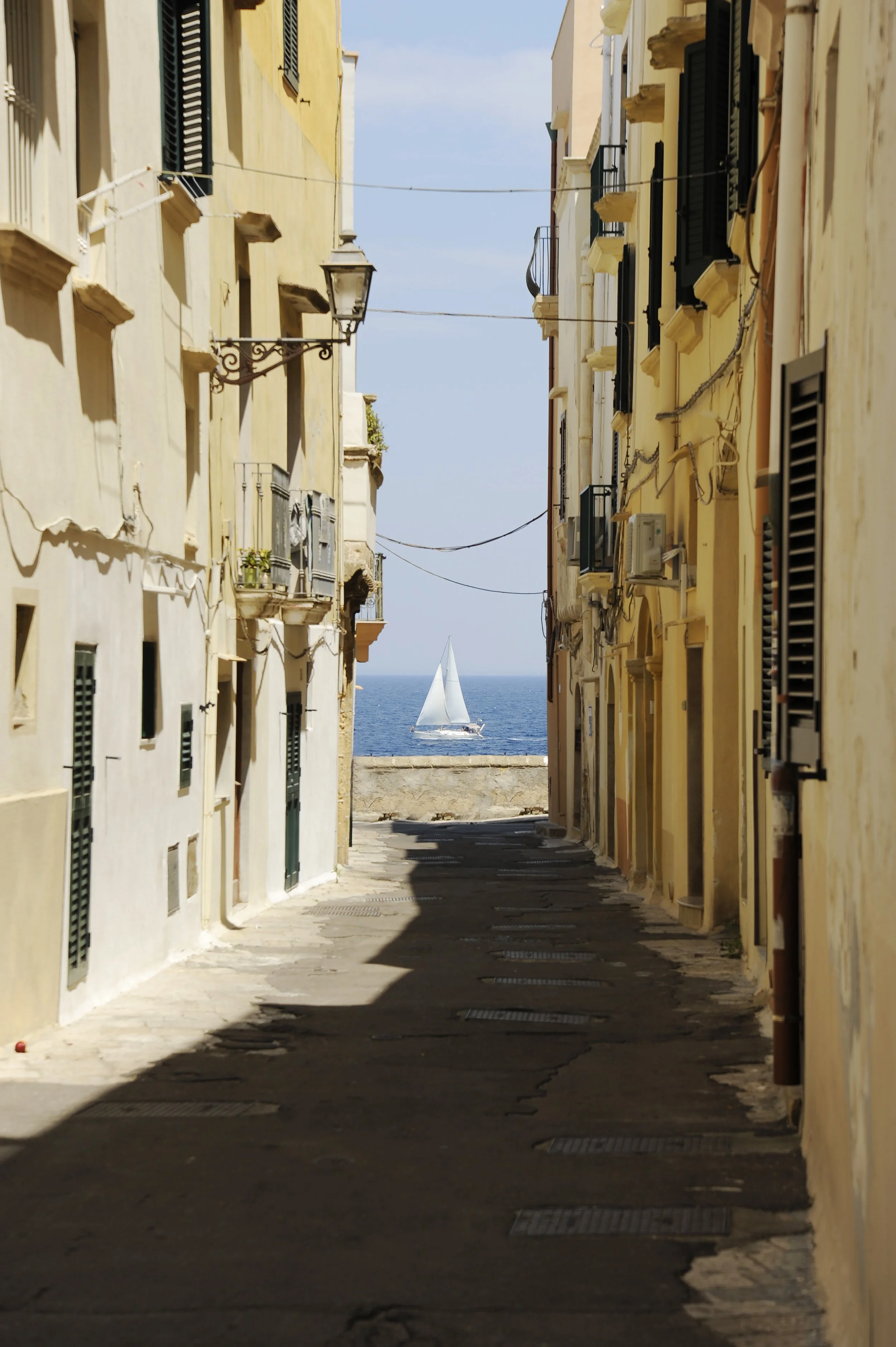 sailboat-is-seen-sea-two-gallipoli-buildings-gallipoli-province-lecce-apulia-italy.jpg