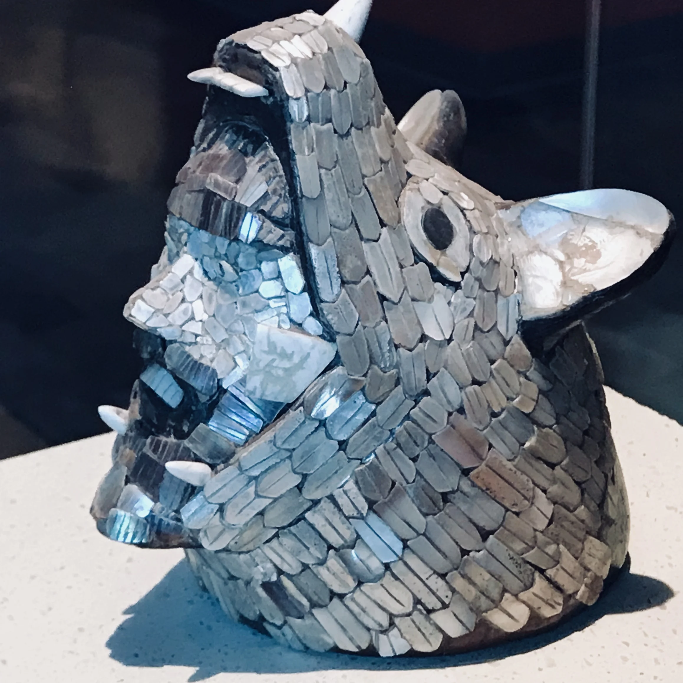 The theme of the jaguar swallowing a man/soldier/conquistador is prevalent. This one is special with its abalone shell scales.