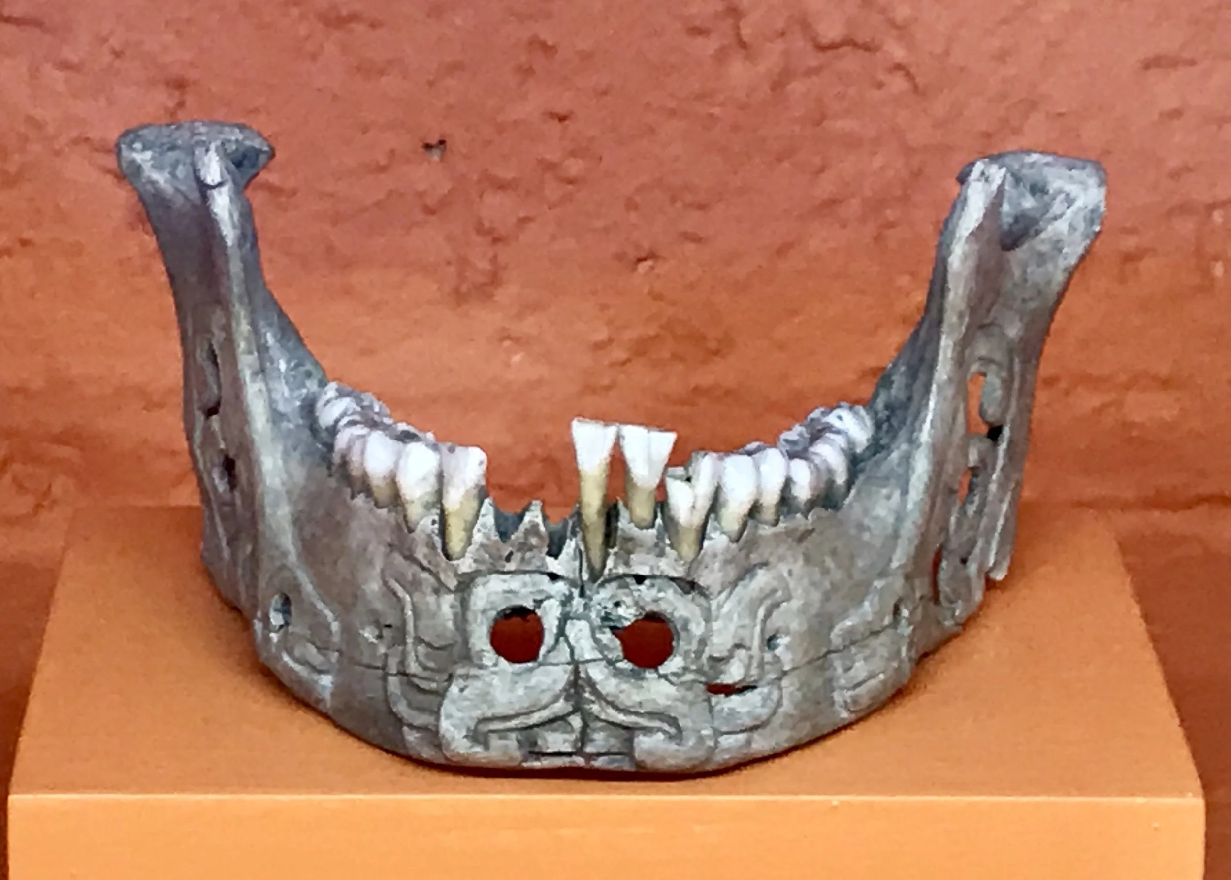 An ornamental carved jaw bone painted silver! Most ceremonial objects like these were buried in the crypts.