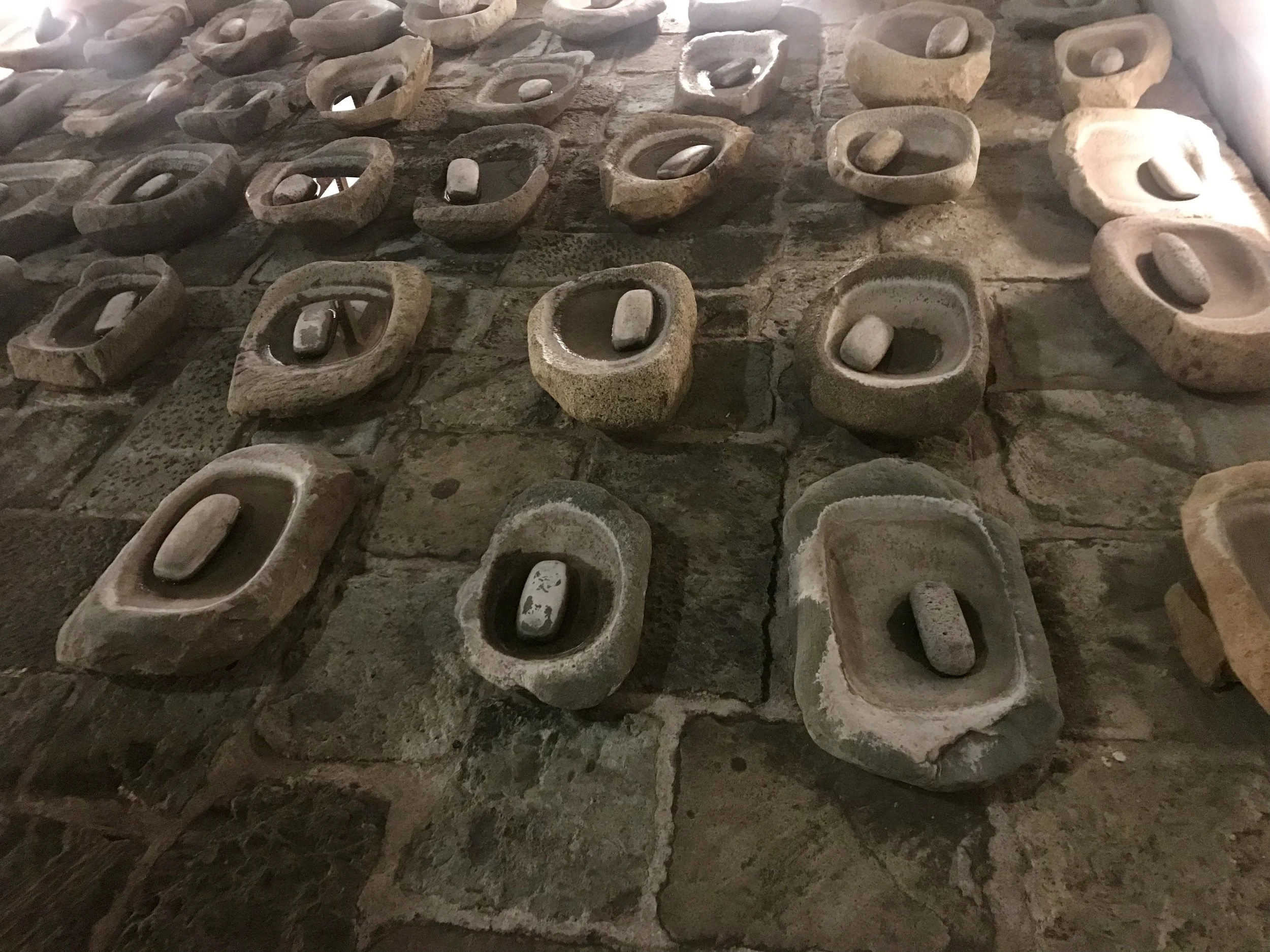 An art installation in a courtyard in Oaxaca brings together ancient functional tools with contemporary art installation.