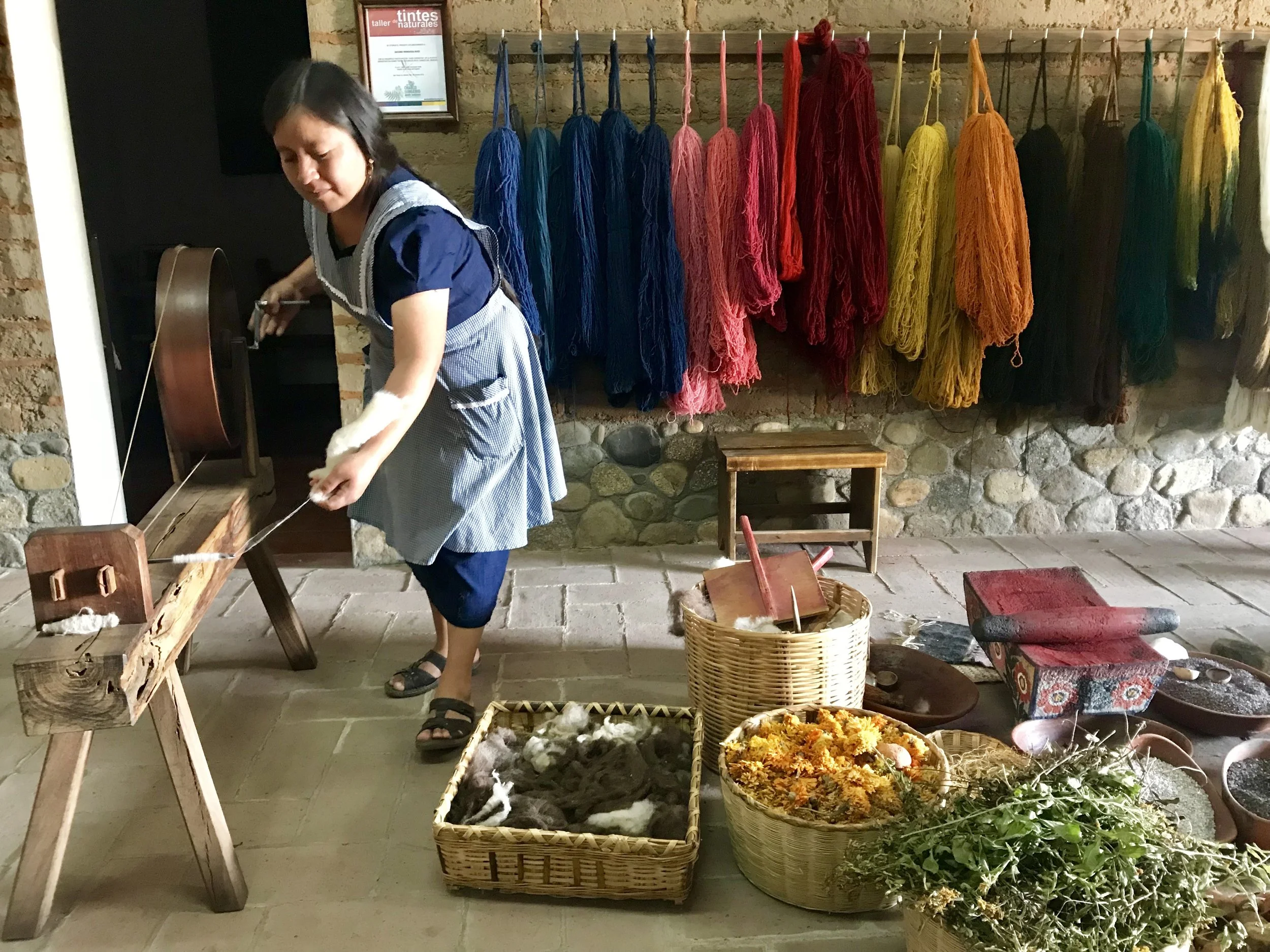 At the Jacobo family of weavers in the village where it’s all about weaving, xxx, mama does the dyeing and spinning demo.