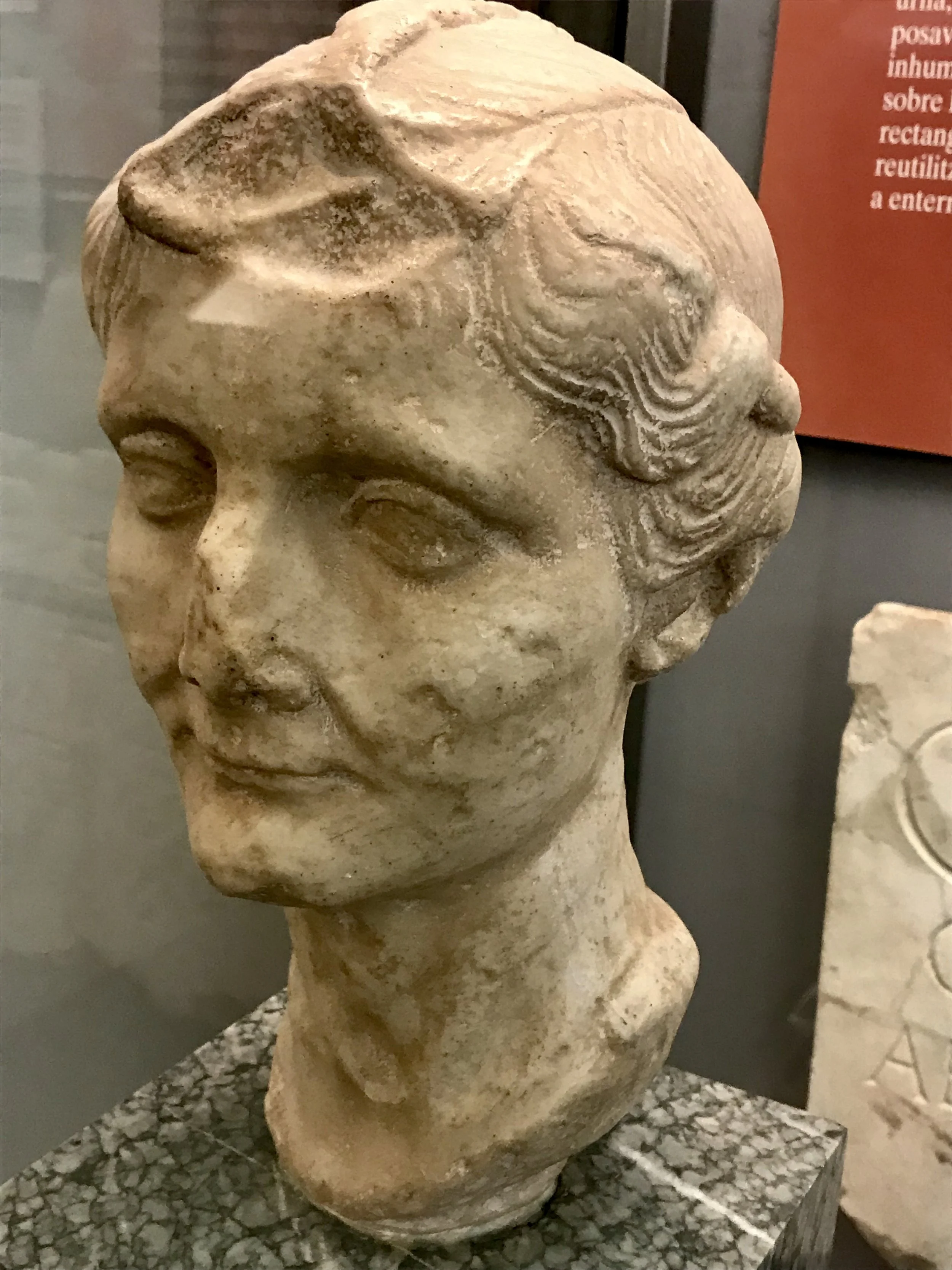 A well-preserved carved stone portrait of a woman from Empúries (Roman) in the archeology museum.