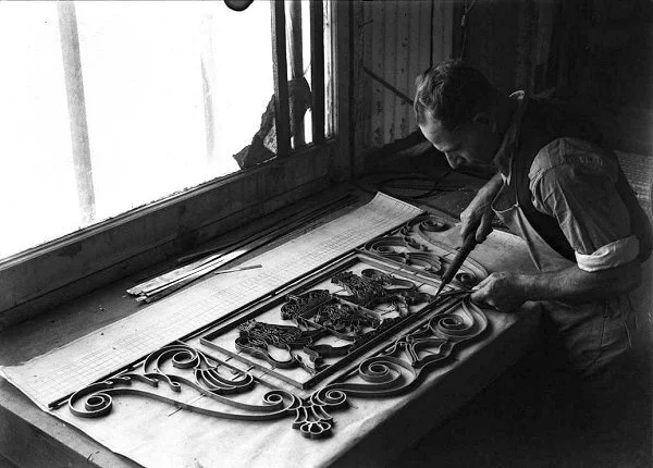 Melocco Bros craftsman making the brass filigree fretwork for a coat of arms for Mitchell Library vestibule floor mosaic 1940. Image: State Library of NSW