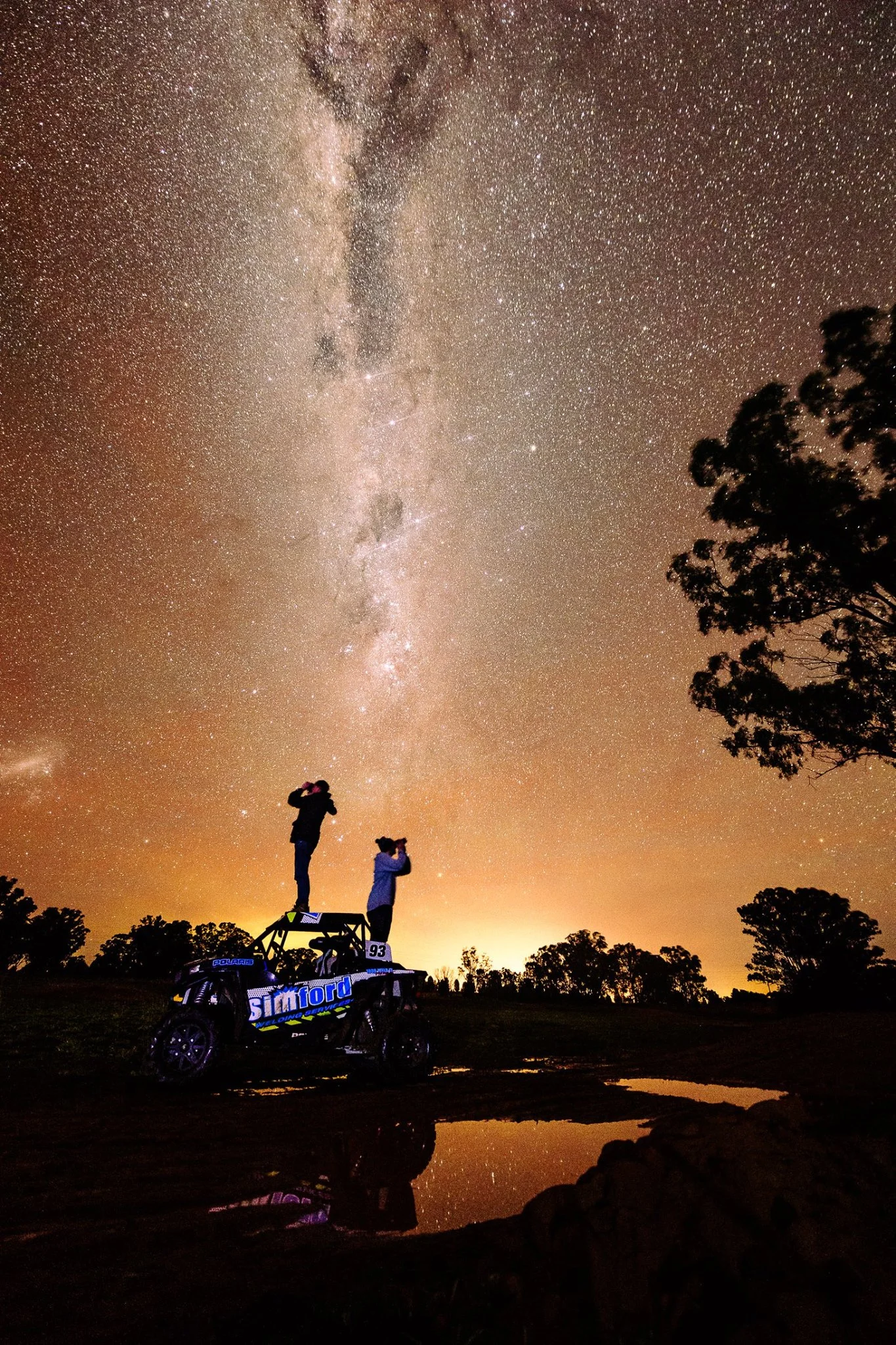 Jim and I standing on an off road buggy under the stars
