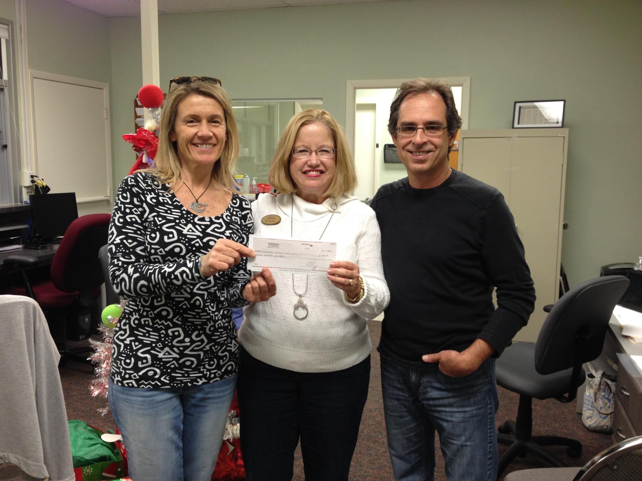 Mango Bistro supports the Englewood Community Care Clinic with a check from their hugely successful wine-tasting fundraiser!