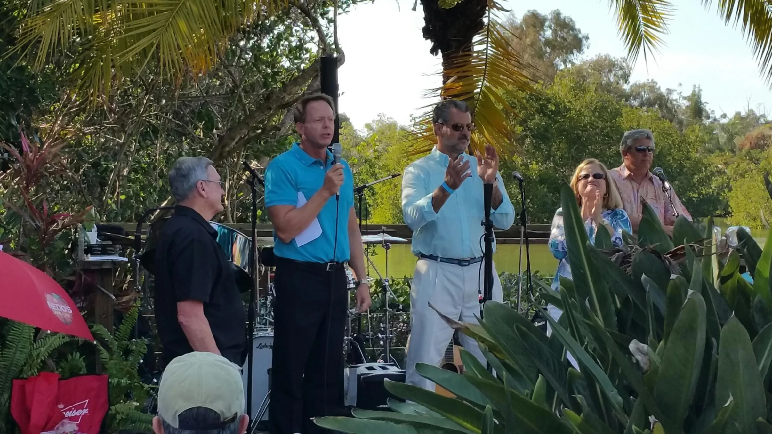 Keith Farlow, Dr. Ray James, and Beth Harrison thank the crowd at Farlow's on the Water for their support of the Englewood Community Care Clinic