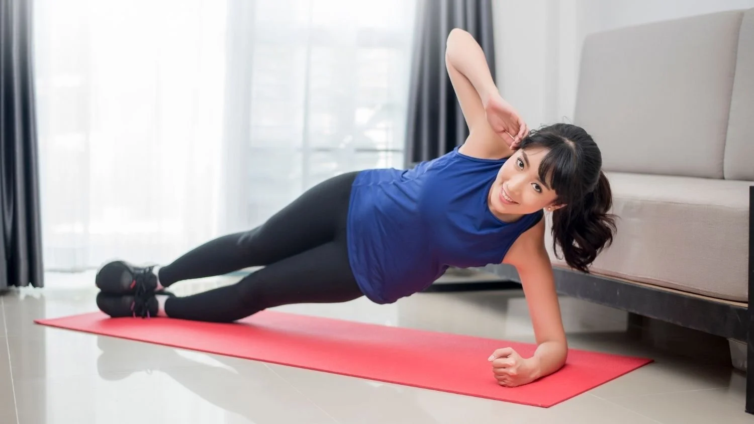 woman doing a side plan as part of the "s" factor workout