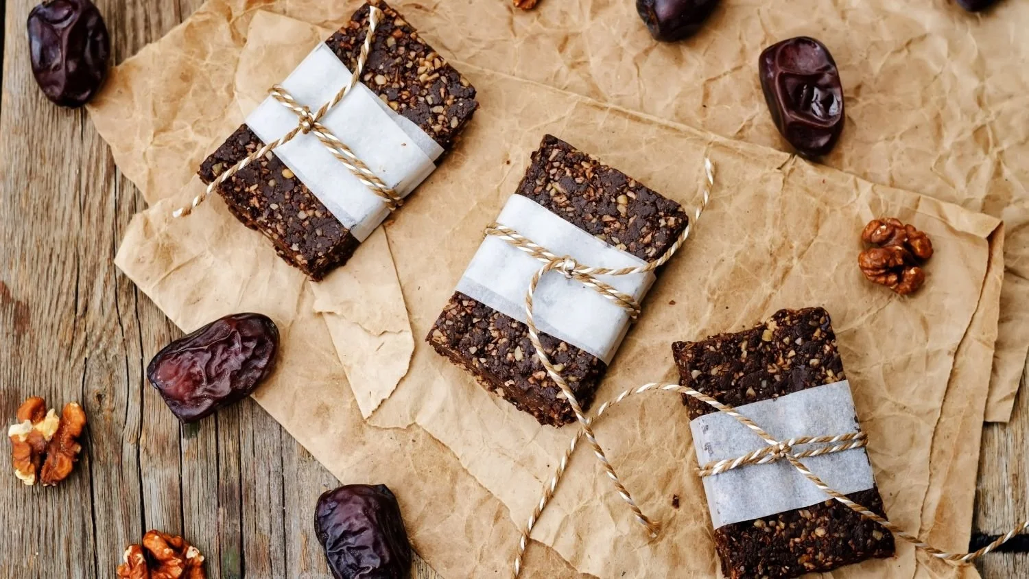 no-bake maple date bars wrapped in paper and string on a table