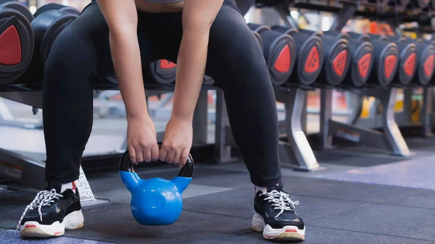 person lifting a kettlebell, you can only see the lower half of them, as they do the bottoms up! workout