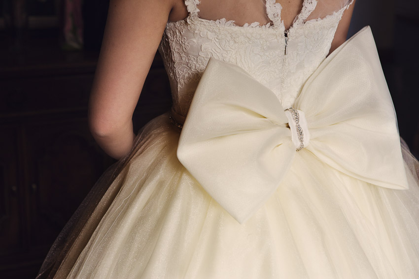 Moe had a custom made skirt for her ceremony with a jeweled belt and bow on back. What a beautiful wedding dress.