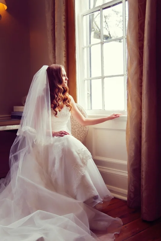 Bride sitting by window Travelers Rest Plantation