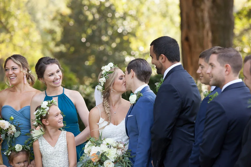 bridesmaid-smiling-at-couple.jpg