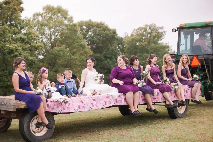 Nashville-wedding-photographer-tractor-bringing-in-wedding-party.jpg