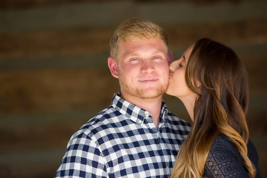 girl-kissing-guy-image-at-legacy-farms-photo-session.jpg