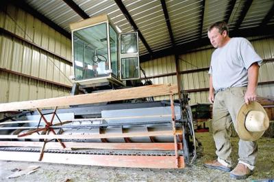 Eric Skokan, of Black Cat Farm and Bistro examines his combine on Monday morning which he purchased from a farmer nearing retirement. ( Devi Chung / For The Camera )