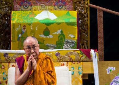 The Dalai Lama prays with the crowd during Thursday's morning session, "Eight Verses of Training the Mind," in the Coors Event Center at the University of Colorado at Boulder. ( Autumn Parry / Staff Photographer )