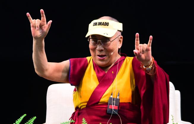 The Dalai Lama signs "I Love You" in response to a question Thursday during the afternoon session Thursday at the Coors Events Center on the University of Colorado at Boulder campus. ( Cliff Grassmick / Staff Photographer )
