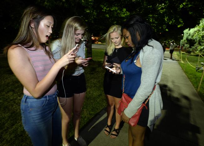 Megan Diller, Emma Dunder, Ashley Berg and Camile Clarke play Pokémon Go along with dozens of other players on a game hotspot on the University of Colorado Boulder Campus early Friday morning. ( Paul Aiken / Staff Photographer )