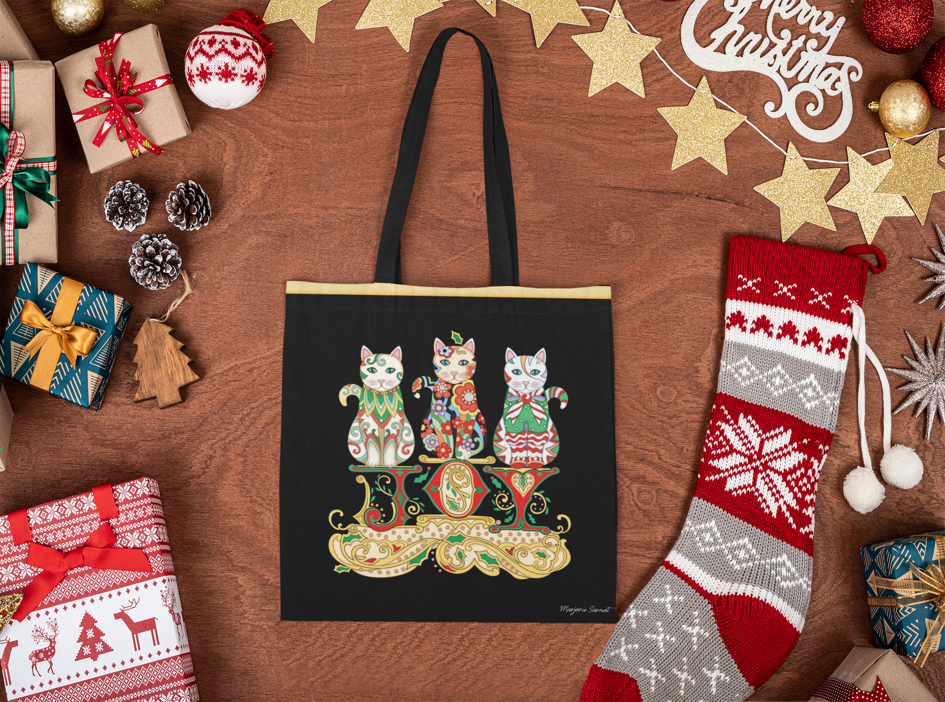 mock_JOY mockup-of-a-tote-bag-placed-on-a-wooden-surface-with-christmas-items-m34.png