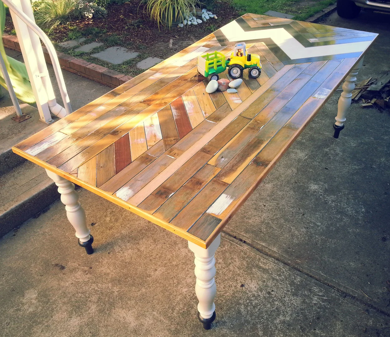 BIN 3 Size : 2500 x 1000 Materials : Reclaimed Jarrah, Cypress and Vic Ash, Coffee stained edging, reclaimed turned legs, acrylic. Finished in a low VOC gloss varnish.