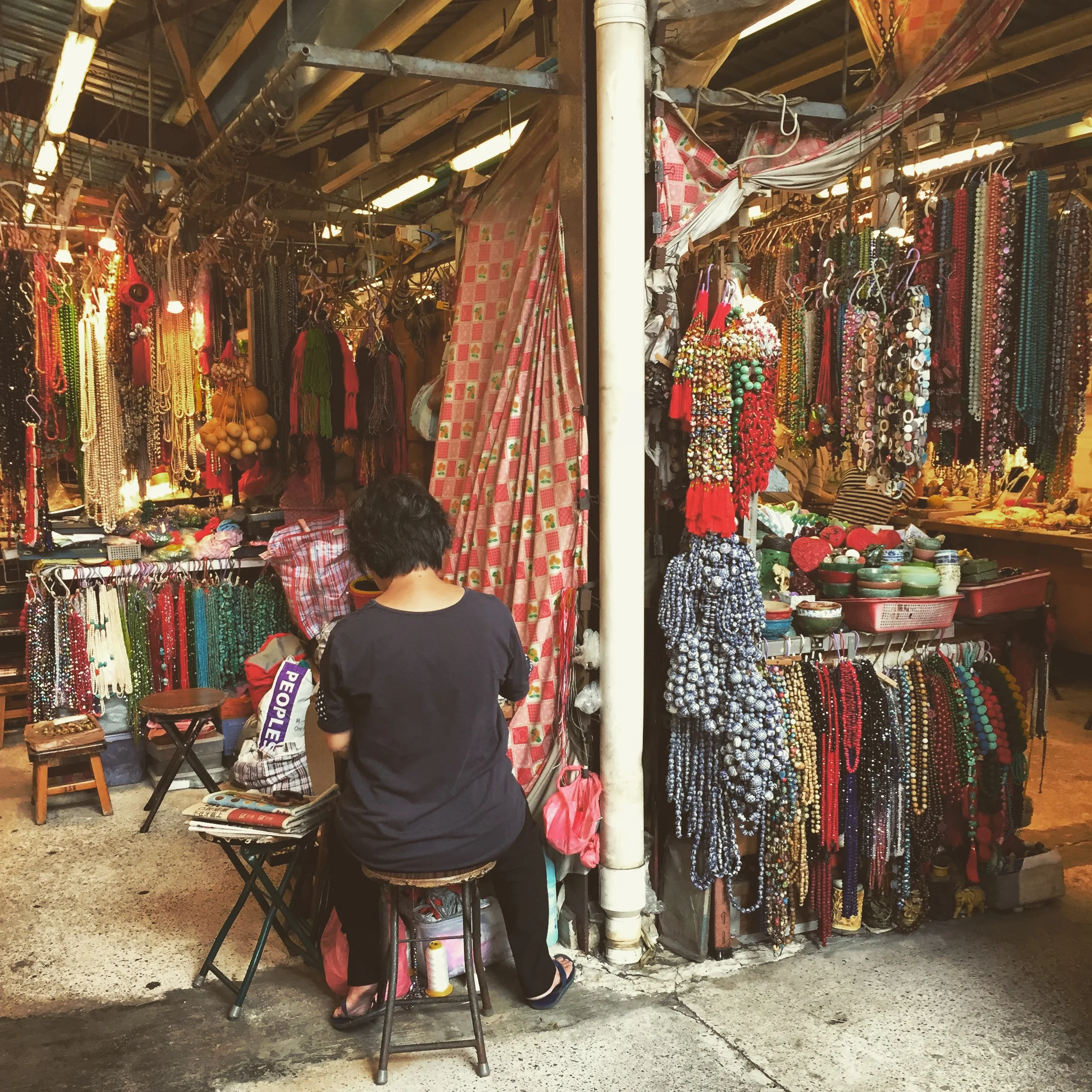 A jewelry maker at work in the Jade Market.