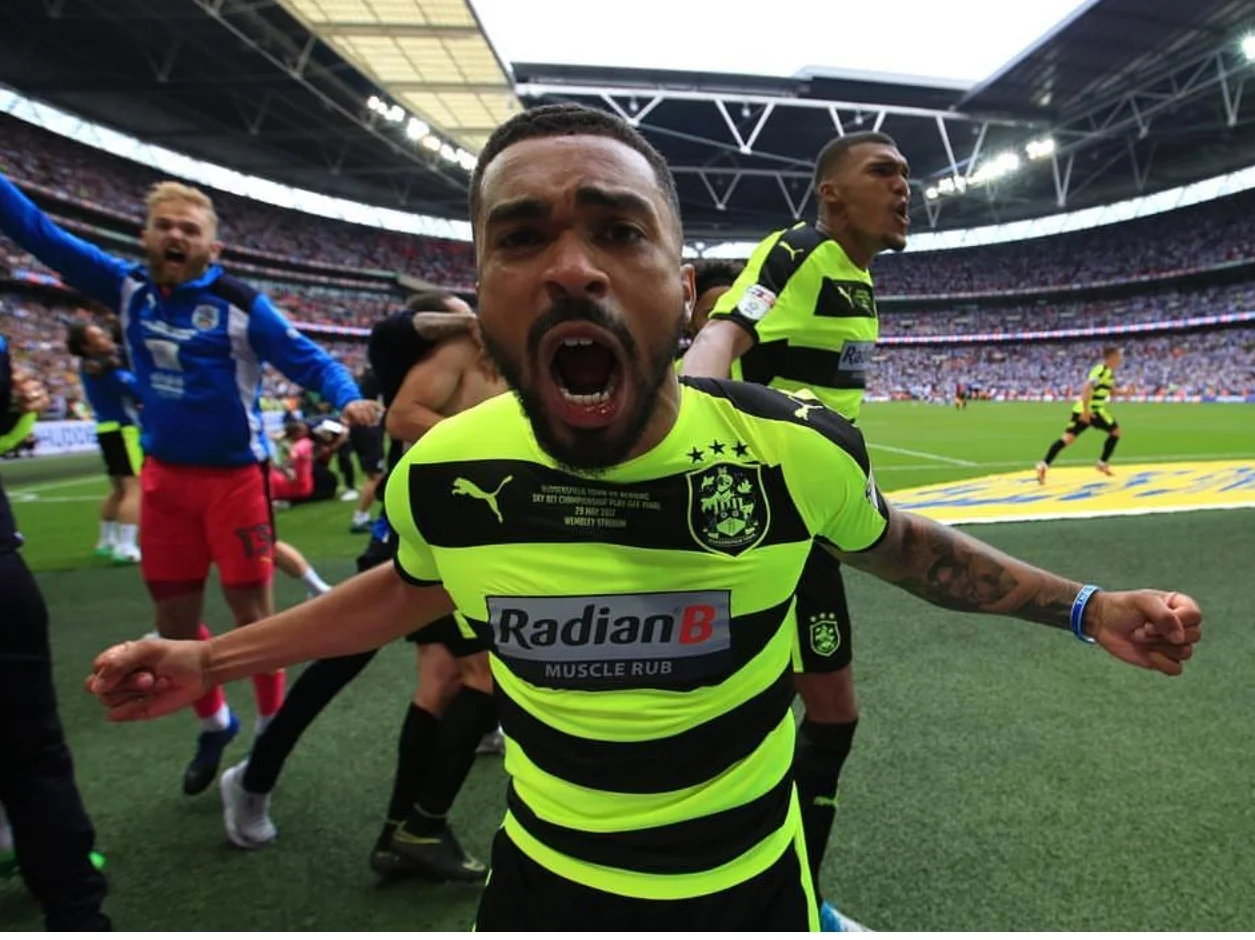 Terriers Defender Tarieq Holmes Dennis celebrates victory