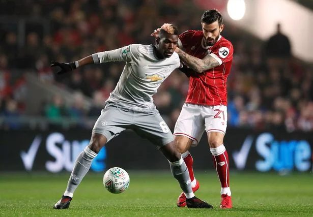 Left: A tightly marked Paul Pogba failed to impose himself on the game on his return to action.